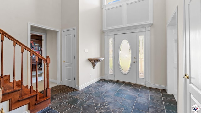 5906 Winchester Dr, Texarkana, TX 75503 - foyer with a high ceiling, plenty of natural light, stairway, and dark stone finish floors