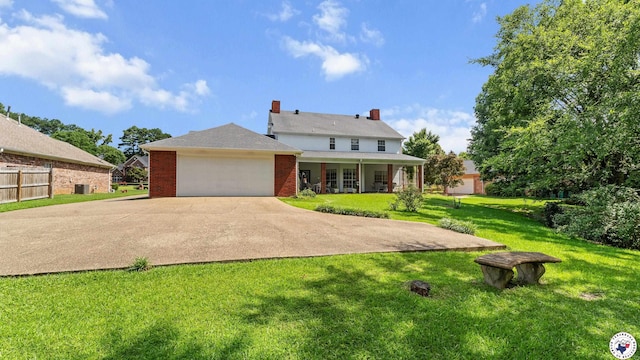 5906 Winchester Dr, Texarkana, TX 75503 - back of property with a garage, brick siding, driveway, and a porch