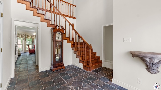 5906 Winchester Dr, Texarkana, TX 75503 - foyer featuring stairway, dark stone finish floors, and a towering ceiling