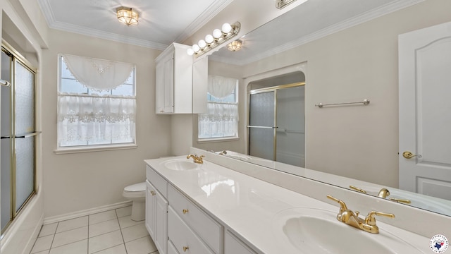 5906 Winchester Dr, Texarkana, TX 75503 - full bath with double vanity, tile patterned floors, ornamental molding, and shower / bath combination with glass door