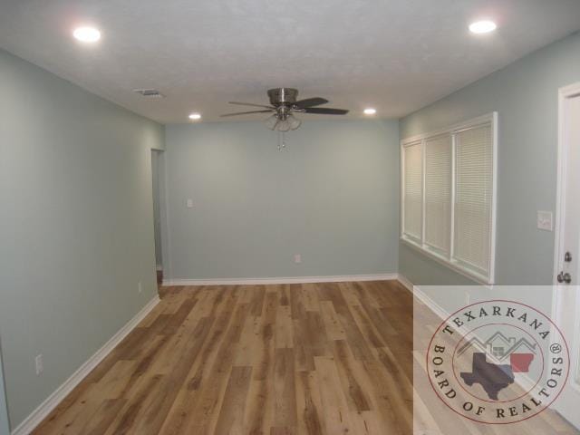 spare room featuring light hardwood / wood-style floors and ceiling fan