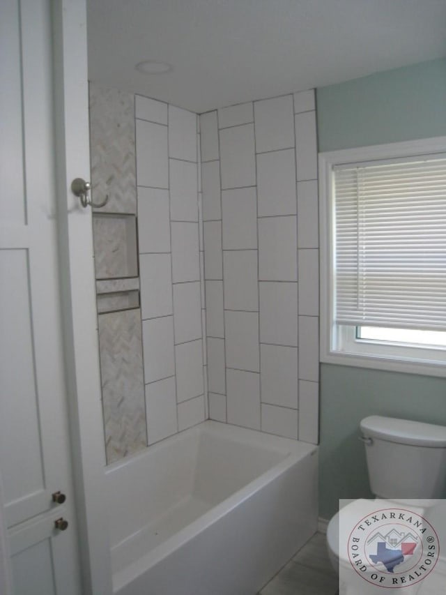 bathroom with tiled shower / bath and tile patterned floors