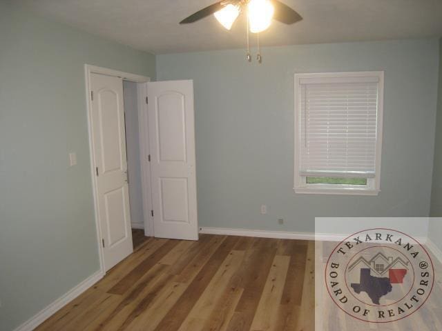 unfurnished bedroom featuring ceiling fan and light hardwood / wood-style flooring