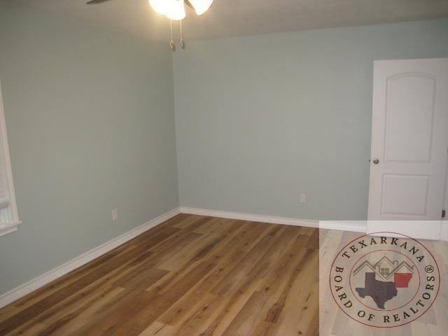 spare room featuring wood-type flooring