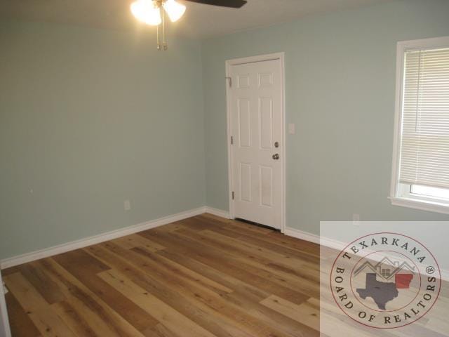 empty room featuring ceiling fan and hardwood / wood-style floors