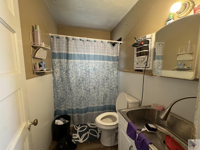 bathroom with sink, hardwood / wood-style floors, and toilet