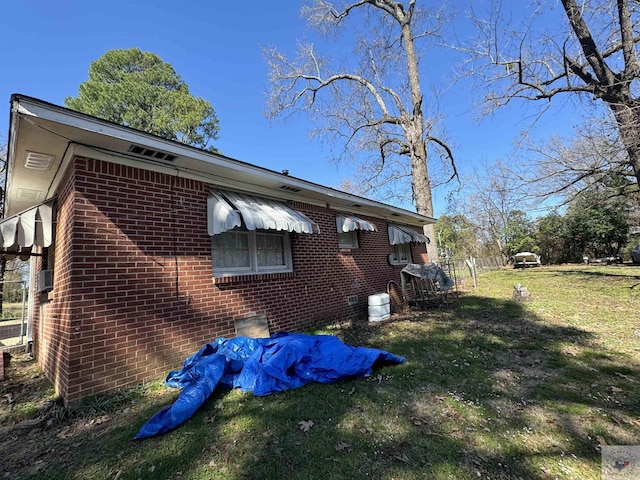 view of side of property with a lawn