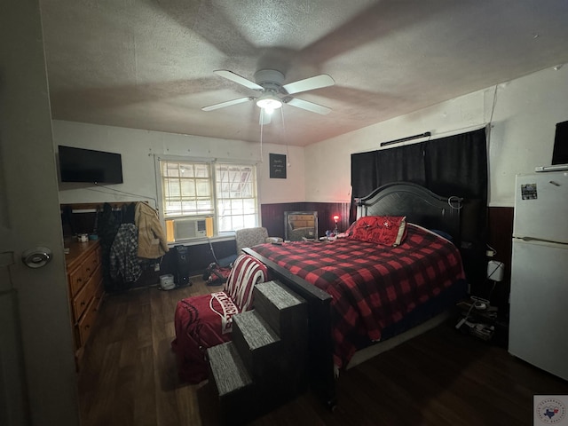 bedroom featuring ceiling fan, a textured ceiling, white refrigerator, and dark hardwood / wood-style flooring