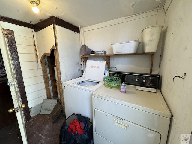 clothes washing area with washing machine and dryer