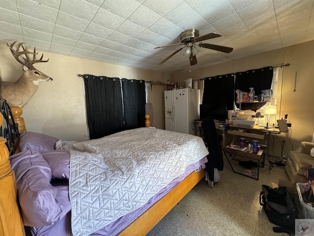 bedroom with white refrigerator with ice dispenser and ceiling fan