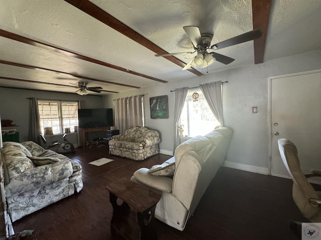 living room featuring ceiling fan, plenty of natural light, a textured ceiling, and dark hardwood / wood-style flooring