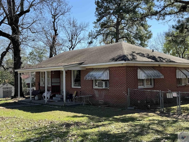 rear view of property with cooling unit, a patio area, and a lawn