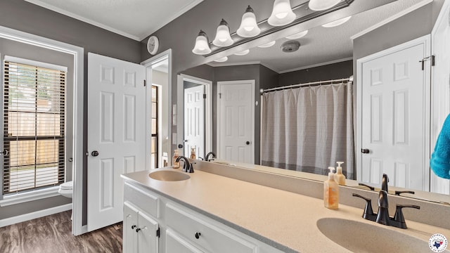 509 Brown Dr, Wake Village, TX 75501 - full bathroom featuring double vanity, wood finished floors, crown molding, and a shower with curtain