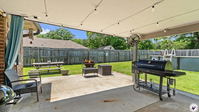 509 Brown Dr, Wake Village, TX 75501 - fenced backyard featuring a patio area, grilling area, and an outdoor fire pit