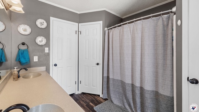 509 Brown Dr, Wake Village, TX 75501 - bathroom with vanity, wood finished floors, crown molding, a shower with shower curtain, and a textured ceiling