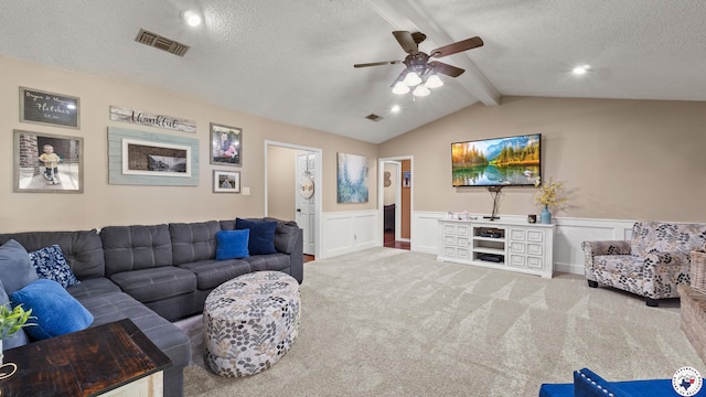 509 Brown Dr, Wake Village, TX 75501 - carpeted living area featuring a wainscoted wall, a textured ceiling, a ceiling fan, and a decorative wall
