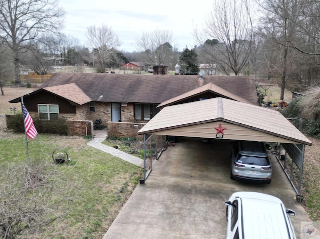 view of front of property featuring a detached carport, concrete driveway, brick siding, and a front lawn