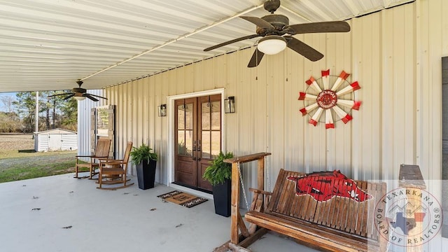 view of patio with an outbuilding, french doors, ceiling fan, and a shed