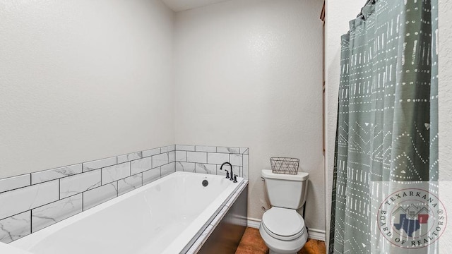 full bathroom featuring toilet, baseboards, and a bath