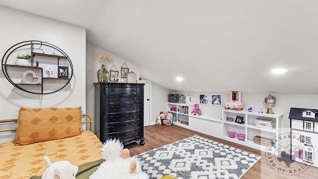 playroom featuring lofted ceiling and wood finished floors