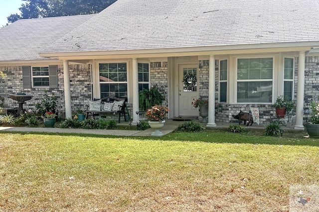 view of exterior entry with a lawn