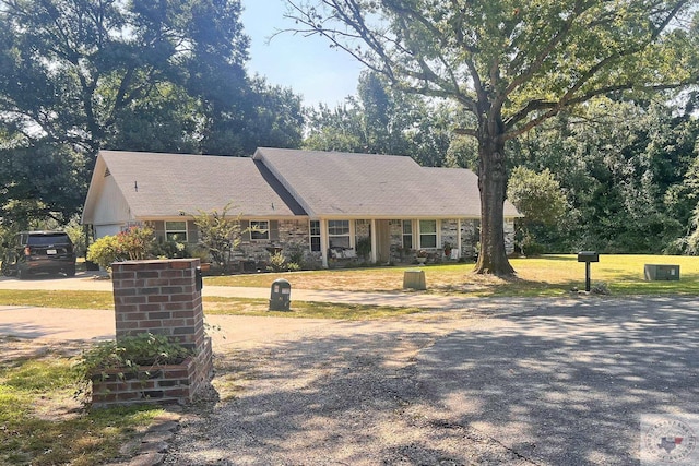 ranch-style home featuring a front yard