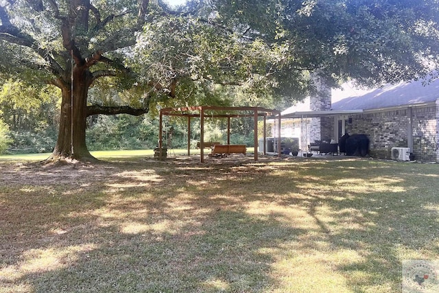 view of yard featuring ac unit and a pergola