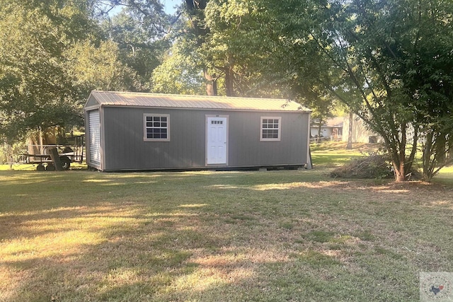 view of outbuilding featuring a yard