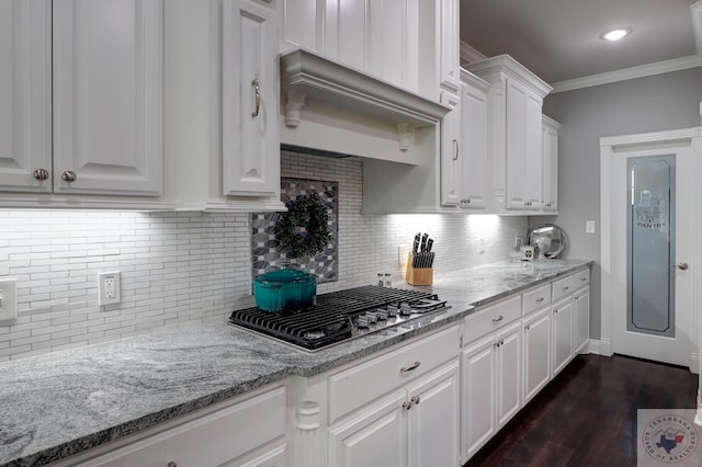 kitchen with light stone counters, backsplash, white cabinetry, and stainless steel gas cooktop