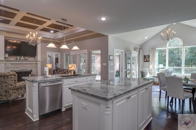 kitchen featuring a center island, dark wood-type flooring, white cabinetry, hanging light fixtures, and stainless steel dishwasher