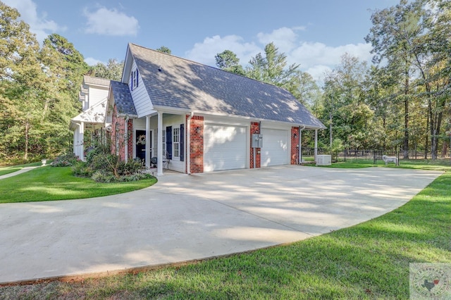 view of home's exterior with a garage and a lawn