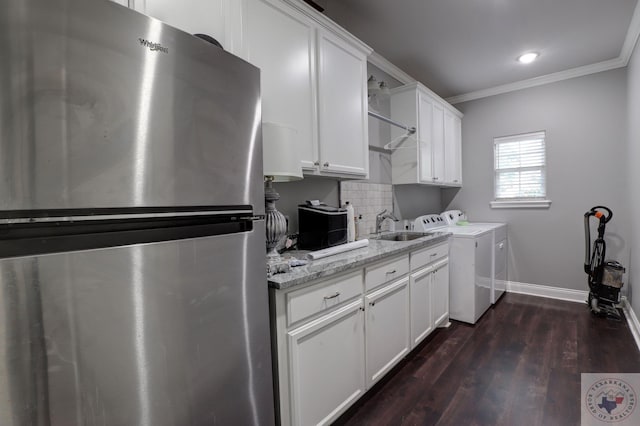 laundry area with sink, independent washer and dryer, dark hardwood / wood-style floors, and ornamental molding