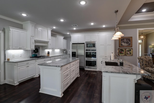 kitchen featuring decorative light fixtures, white cabinets, and appliances with stainless steel finishes