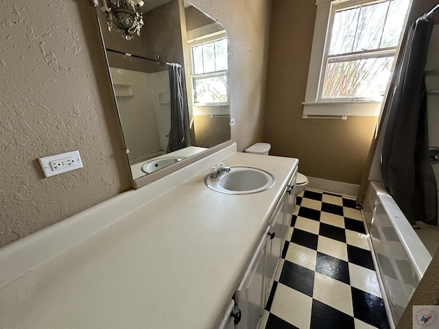 full bathroom with vanity, toilet, and shower / tub combo