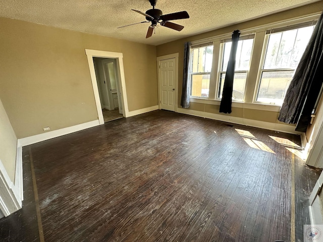 unfurnished bedroom with a textured ceiling, dark hardwood / wood-style floors, and ceiling fan