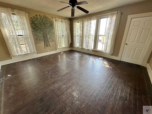 spare room featuring hardwood / wood-style flooring, a textured ceiling, and ceiling fan