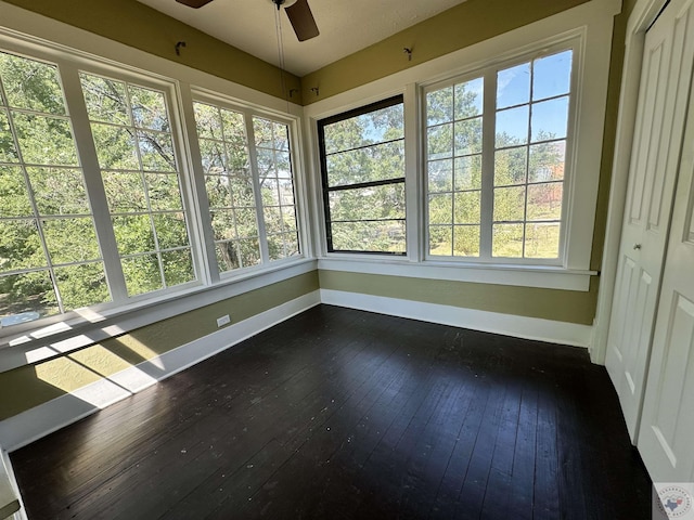 unfurnished sunroom with ceiling fan