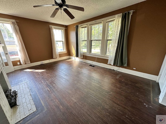 empty room featuring ceiling fan, dark hardwood / wood-style floors, and a textured ceiling