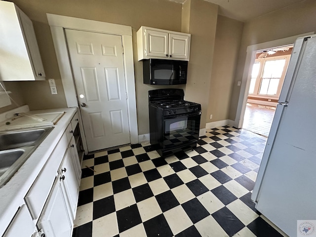 kitchen featuring sink, white cabinets, and black appliances