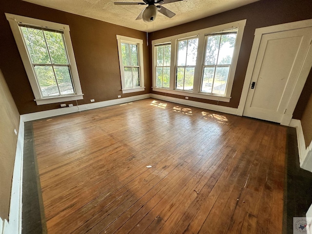 spare room with ceiling fan, hardwood / wood-style floors, and a textured ceiling