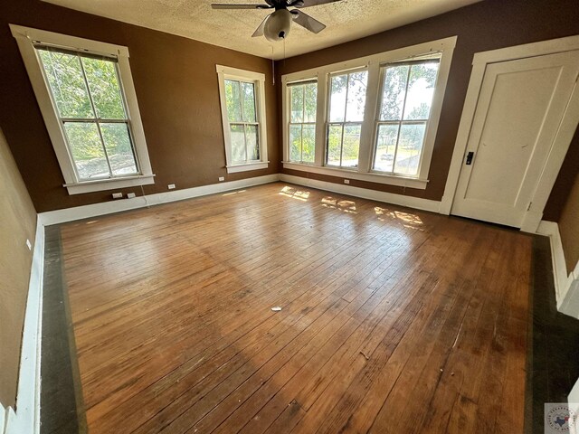 spare room with ceiling fan, hardwood / wood-style floors, and a textured ceiling