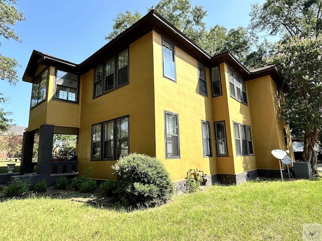 exterior space with a yard and central AC unit