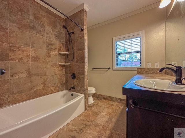 full bathroom with vanity, toilet, ornamental molding, and tiled shower / bath