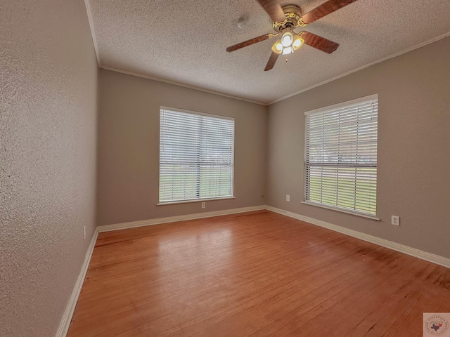 spare room with crown molding, light hardwood / wood-style floors, and a textured ceiling