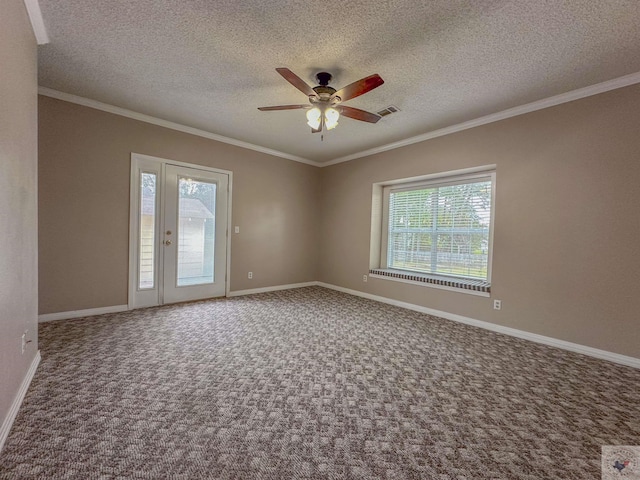 carpeted spare room with ceiling fan, a wealth of natural light, ornamental molding, and a textured ceiling