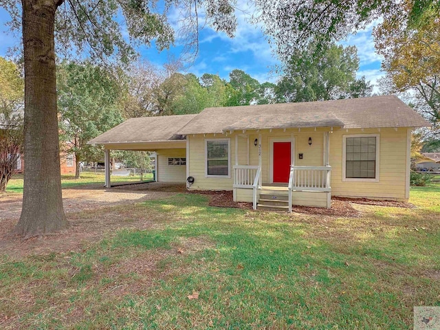 ranch-style house with a front yard and a carport