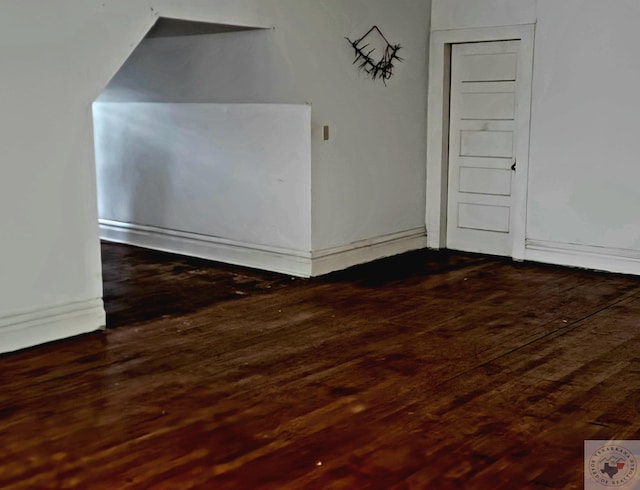 empty room with dark hardwood / wood-style flooring