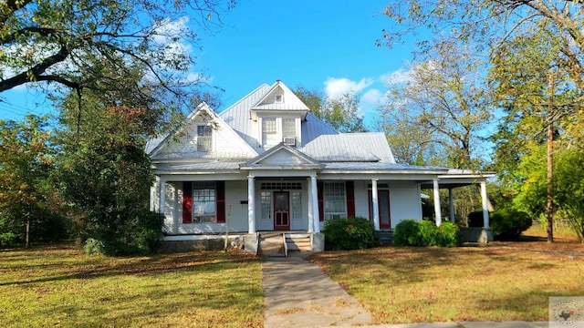 view of front of home with covered porch and a front lawn