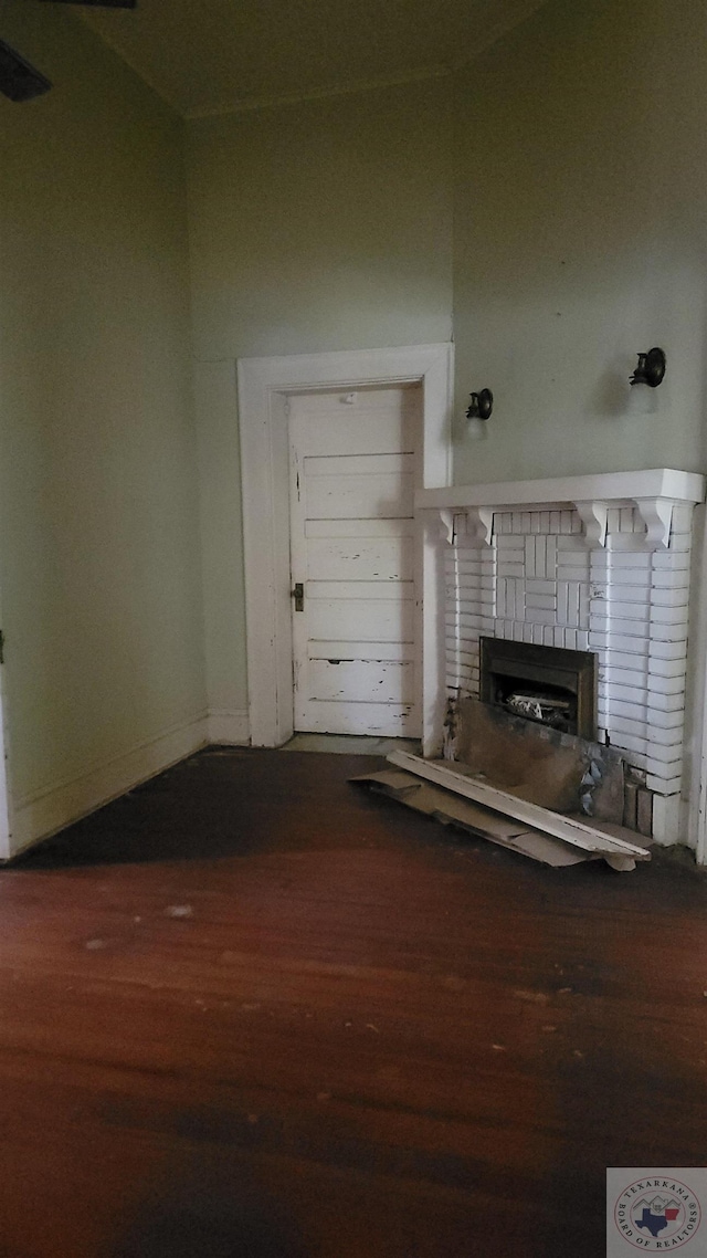 unfurnished living room with hardwood / wood-style flooring and a fireplace