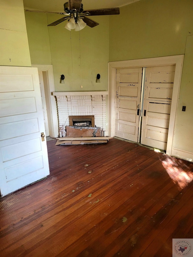 unfurnished living room with a fireplace, hardwood / wood-style floors, and ceiling fan